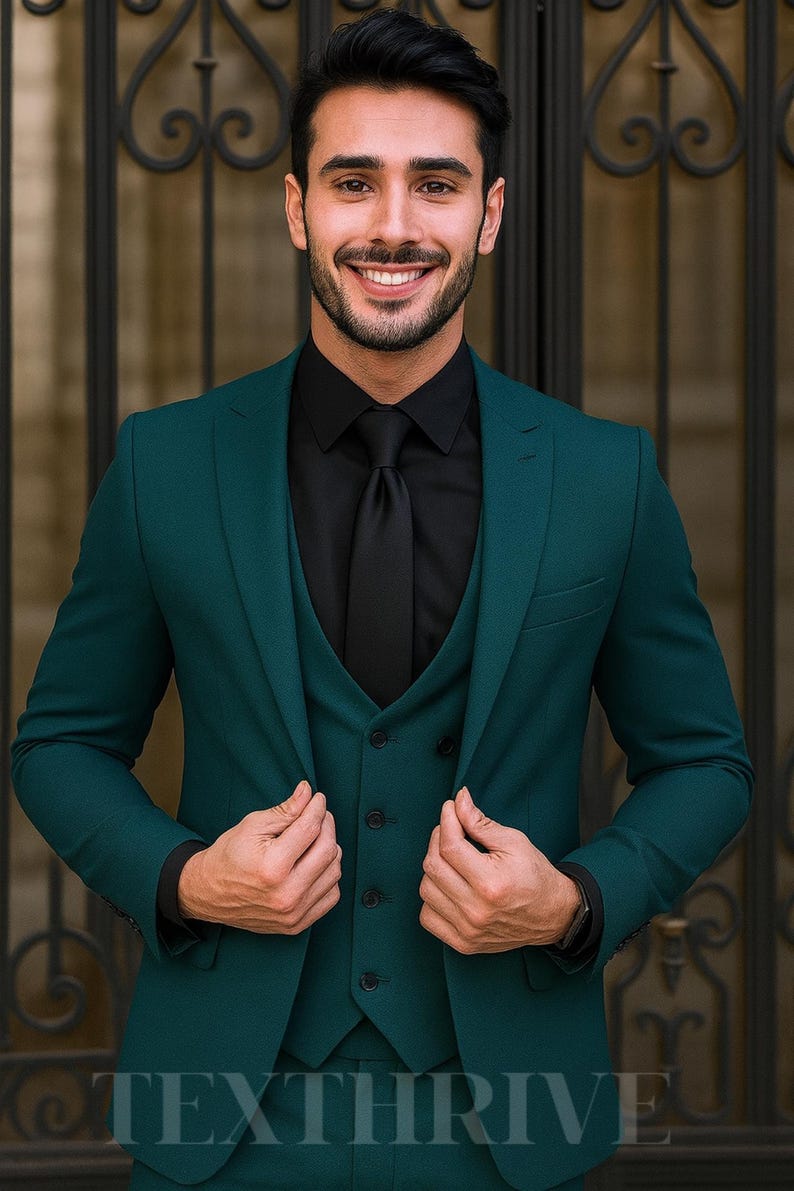 May include: A three-piece teal suit with a black shirt and tie. The suit jacket is buttoned, and the vest is visible. The person is smiling. The image includes the text "TEXTHRIVE" at the bottom.