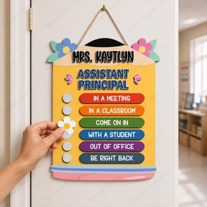 May include: A yellow pencil-shaped wooden door sign featuring the text Mrs. Kaytlyn Assistant Principal. It includes six colorful status bars: In a Meeting, In a Classroom, Come On In, With a Student, Out of Office, and Be Right Back.