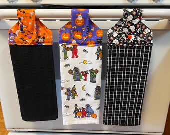 Halloween characters hanging kitchen towels with snaps