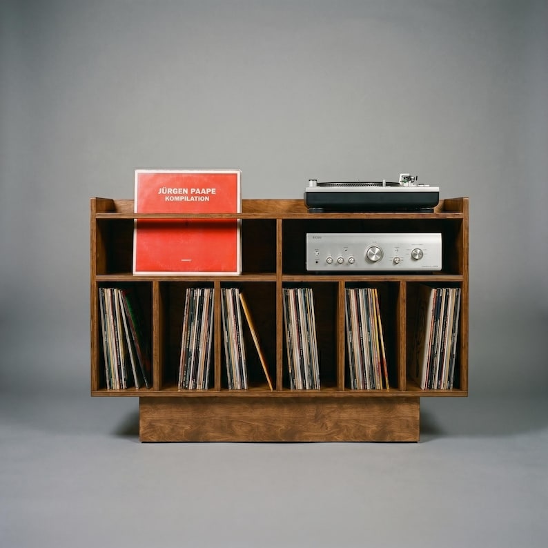 Front view of Groove No.3 walnut finish record player stand with turntable platform, silver amplifier shelf, album display area, and vertical vinyl record storage.