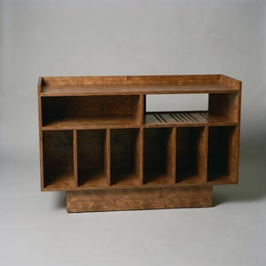 Walnut record player stand with open turntable shelf, receiver space, cable management, ventilation slots, and six vinyl storage compartments for home audio organization.