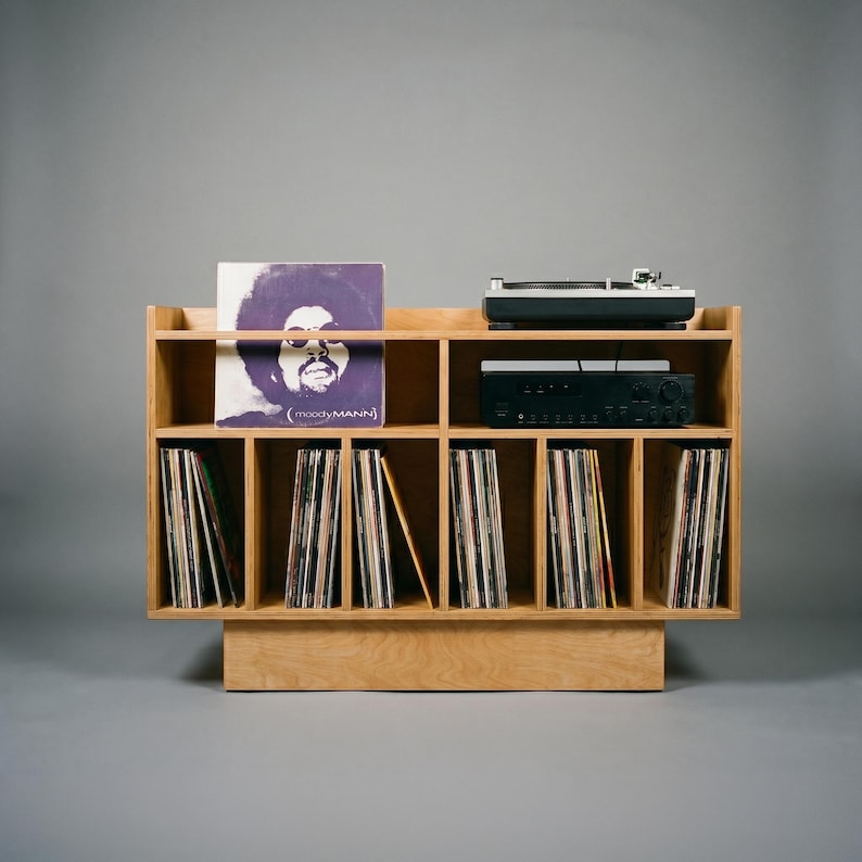 Front view of Groove No.3 record player stand in natural birch plywood with turntable platform, amplifier shelf, and six vertical vinyl record storage sections.