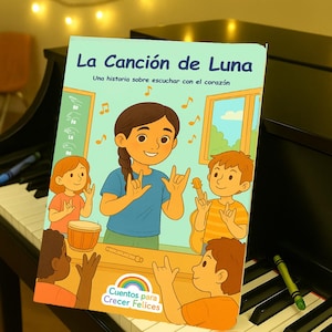 May include: A children's book titled "La Canción de Luna" with illustrations of children and musical notes. The cover features a girl signing and the text "Una historia sobre escuchar con el corazón". The book is on a piano.