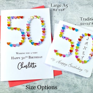 May include: Two handmade birthday cards with the number 50 made from colorful hearts. The larger card is 8.3 inches by 5.8 inches and the smaller card is 5.5 inches by 5.5 inches. The larger card says "Wishing you a very happy 50th birthday Charlotte". The smaller card says "Happy Birthday".