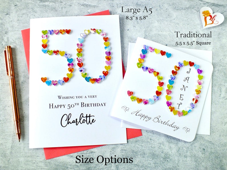 May include: Two handmade birthday cards with the number 50 made from colorful hearts. The larger card is 8.3 inches by 5.8 inches and the smaller card is 5.5 inches by 5.5 inches. The larger card says "Wishing you a very happy 50th birthday Charlotte". The smaller card says "Happy Birthday".