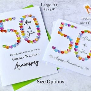 May include: Two white greeting cards with the number 50 made of colourful hearts. The cards are for a golden wedding anniversary and are personalised with the names Alice and John. The larger card is 8.3 inches by 5.8 inches and the smaller card is 5.5 inches by 5.5 inches.