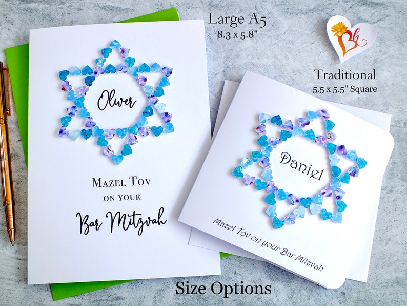 May include: Two white cards with blue and purple heart-shaped embellishments forming a Star of David. The cards are personalized with the names "Oliver" and "Daniel" and the text "Mazel Tov on your Bar Mitzvah". The cards are available in two sizes: 8.3 x 5.8 inches and 5.5 x 5.5 inches.