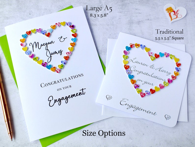 May include: Two engagement cards with a heart made of colorful paper hearts. The larger card is 8.3 inches by 5.8 inches and says "Maegan & James Congratulations on your Engagement". The smaller card is 5.5 inches by 5.5 inches and says "Lauren & Harry Congratulations on your Engagement".