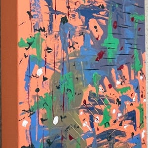 May include: A rectangular canvas painting featuring an orange background layered with abstract brushstrokes in blue, green, black, and white. The composition includes vertical and horizontal paint marks, splatters, and drips across the surface.
