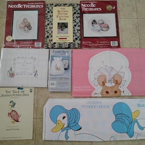 May include: Assortment of Beatrix Potter themed items, including cross-stitch kits, a knitting book, a gift bag, a nursery classic, and a book titled "The Tale of Jemima Puddle-Duck". The items feature illustrations of Peter Rabbit and other characters.