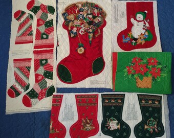 4 pre-quilted Christmas stocking panels & 6 oval placemats Various sized stockings. Placemats poinsettia design 18.5" x 13" w. foam middle.