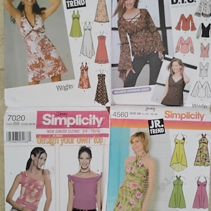 May include: Four Simplicity sewing pattern envelopes featuring women's clothing designs. The patterns include dresses, tops, and blouses. The envelopes are labeled with the Simplicity and Jr. Trend logos.