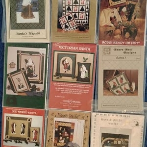 Eight Santa and one snowman quilt patterns. Quilts, wall hangings appliques for totes, sweatshirts & decor, Santa mantle all complete uncut