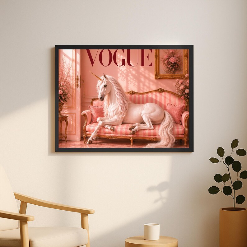 May include: A framed print featuring the word "VOGUE" in a bold, red font. The image depicts a white unicorn reclining on a pink striped sofa. The unicorn has a golden horn and a flowing mane and tail. The room is decorated in shades of pink.