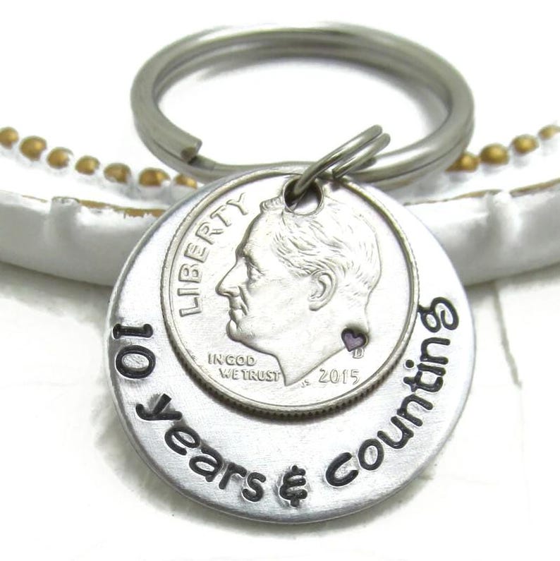 10th anniversary keychain made from a US dime, hand stamped with personalized details, featuring aluminum and metal elements as a traditional 10-year wedding gift for him