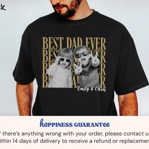 Pu&ograve; includere: T-shirt nera con grafica dorata che recita "BEST DAD EVER" e presenta una foto in bianco e nero di due bambini con occhiali da sole. I nomi "Emily & Chris" sono stampati sotto.