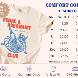 May include: A cream-colored short-sleeve t-shirt featuring a blue graphic of a raccoon wearing sunglasses with the red text FERAL & PREGNANT CLUB and don't touch me. A size chart lists widths and lengths in inches from S to 3XL. Text includes 100% Cotton, Garment-Dyed, Unisex Fit, and DTG Printing.
