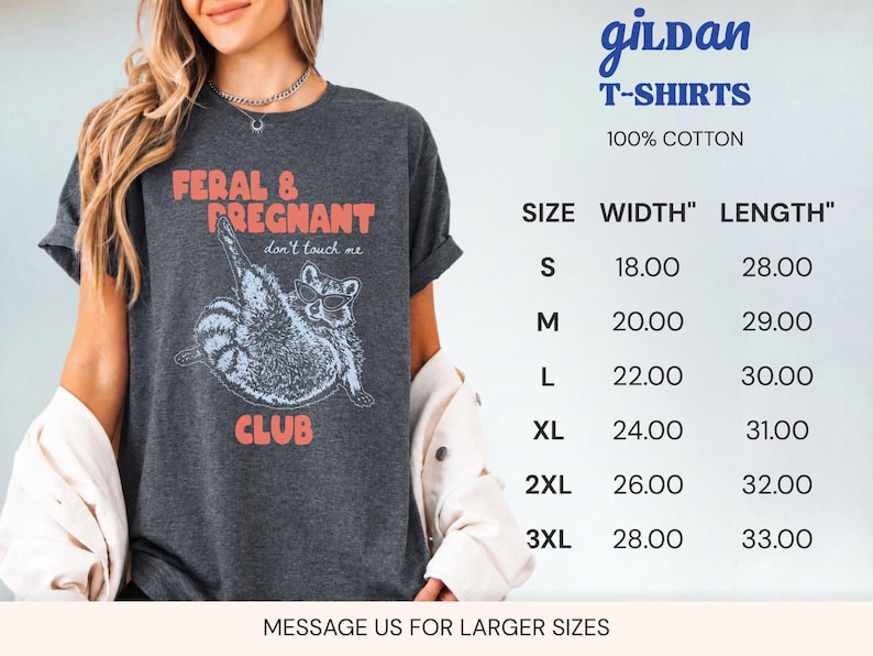 May include: A dark gray short-sleeve t-shirt featuring a graphic of a raccoon wearing sunglasses with the text FERAL & PREGNANT don't touch me CLUB. A size chart is visible with width and length measurements in inches for sizes S to 3XL.