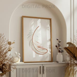 Puede incluir: Una impresión artística enmarcada con una pluma estilizada en tonos cobre y gris sobre un fondo blanco. La obra de arte se muestra en un marco de madera marrón claro. El texto "DIGITAL PROR" es visible en la parte superior.