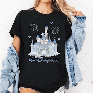 May include: Black t-shirt with a light blue illustration of a castle, fireworks, and the text "Walt Disney World". The castle has multiple towers and is set against a cloudy background.