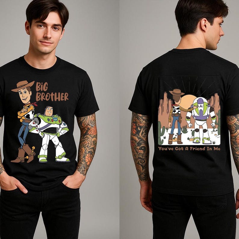 May include: Black t-shirt featuring cartoon characters Woody and Buzz Lightyear from Toy Story. The front of the shirt has the text "Big Brother". The back of the shirt has the text "You've Got A Friend In Me".