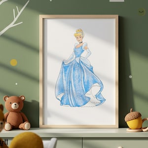 May include: A framed watercolor print of Cinderella in a light blue ball gown. The artwork features a blonde-haired woman with a choker and gloves. The print is displayed on a green wall with a tree and yellow accents. A brown teddy bear and yellow acorn mugs are in the foreground.