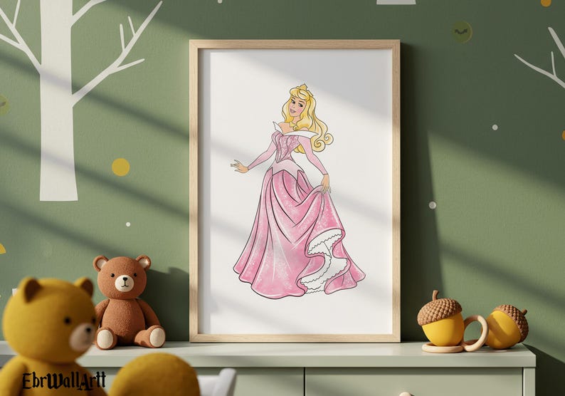 May include: A framed print featuring a watercolor illustration of a princess in a pink gown. The princess has blonde hair and is holding the skirt of her dress. The print is displayed on a green wall with a tree design.