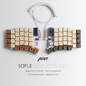 May include: A split keyboard with off-white and brown keycaps, connected by a white coiled cable. The keyboard is labelled "SOFLE SPLIT KEYBOARD" and includes the text "Beginner-Friendly • Mac Compatible • Fully Assembled • Ready to Use".