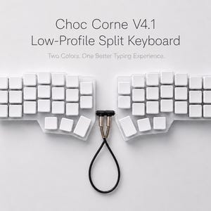 May include: A Choc Corne V4.1 low-profile split keyboard with white keycaps on a clear base. The two halves are connected by a black TRRS cable with metallic connectors. The text reads: Choc Corne V4.1 Low-Profile Split Keyboard. Two Colors. One Better Typing Experience.