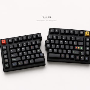 Peut inclure: Un clavier mécanique scindé noir portant l'inscription Split 89 Wireless 2.4G Vial Remappable. L'appareil présente des touches noires avec des lettres blanches, une touche échap rouge, une touche de fonction jaune et trois voyants lumineux.