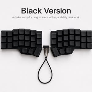 May include: A black split ergonomic keyboard with blank keycaps. The two halves are connected by a central bridge and a black cable loop. Text above reads: Black Version. A darker setup for programmers, writers, and daily desk work.