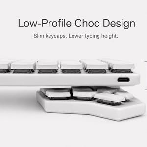 May include: A white mechanical keyboard with a low-profile Choc design, featuring slim white keycaps and black switches. The text reads Low-Profile Choc Design, Slim keycaps. Lower typing height. A measurement indicator shows a height of 17 mm.