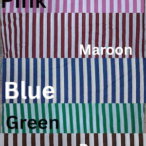 May include: A fabric sample featuring vertical stripes in various colors. The colors include pink, maroon, blue, green, brown, and yellow. Each color has a white stripe separating it from the next. The names of the colors are written in white text.