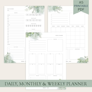 Op de afbeelding: Printbare plannerpagina's met dagelijkse, wekelijkse en maandelijkse lay-outs. De pagina's bevatten secties voor planning, stemmingstracking en takenlijsten. Versierd met aquarel bloemaccenten, dragen de pagina's de tekst "DAILY, MONTHLY & WEEKLY PLANNER".