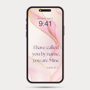 May include: A smartphone with a purple frame displays a lock screen with a pink and gold abstract design. The screen shows the time 9:41, the date, and the text "I have called you by name, you are Mine" from Isaiah 43:1.