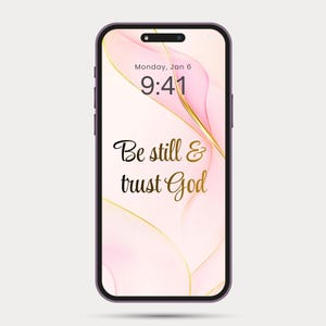 May include: A smartphone with a purple frame displays a wallpaper with a pink and gold abstract design. The lock screen shows the time, date, and the text "Be still & trust God" in elegant script.