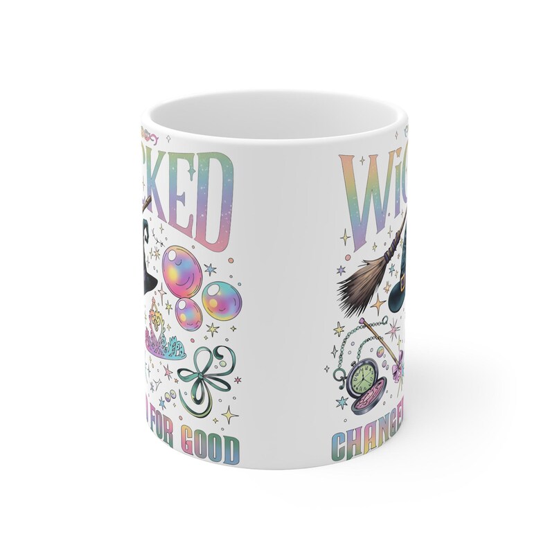 May include: White ceramic mug with the words "Wicked" and "Witch" in a rainbow gradient font. The mug features whimsical illustrations of a witch's hat, bubbles, a broom, and a pocket watch. The text "Changed for Good" is also visible.