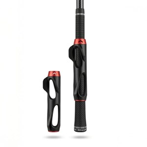 May include: Black and red golf club grip training aid. The grip has a textured surface and a red accent. The training aid is designed to help golfers improve their grip and swing. The training aid is shown with a detached piece.