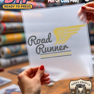 May include: A clear DTF (Direct to Film) transfer sheet with the words "Road Runner" and a yellow wing graphic. The sheet also includes the text "Always Lead the Road" and instructions for application.