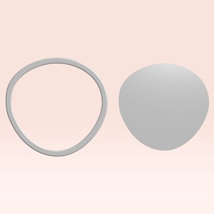 May include: Two grey, abstract shapes against a light pink background. One shape is a rounded, irregular ring. The other is a smooth, oval shape. The objects appear to be 3D rendered.