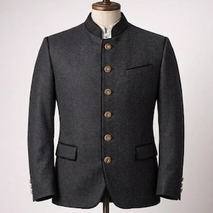 May include: A dark gray blazer with a mandarin collar and gold buttons. The tailored jacket features a small chest pocket and black trim on the collar, pockets, and cuffs. The blazer is displayed on a wooden mannequin.