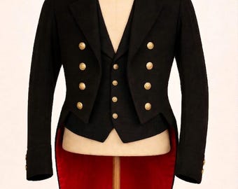 May include: A black formal jacket and vest set with gold-colored buttons. The jacket has a tail and a red lining. The vest has a V-neck and a row of buttons down the front. The jacket and vest are displayed on a wooden mannequin.