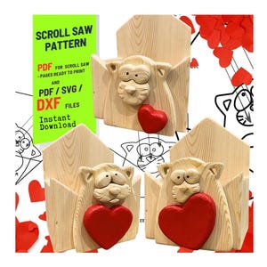 May include: Three wooden cat-themed wall organizers, each with a carved cat face and a red heart. The organizers are made of light-colored wood. A green sign reads "SCROLL SAW PATTERN" and "PDF/SVG/DXF FILES".