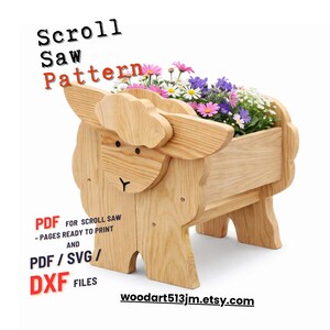 May include: A wooden sheep-shaped planter filled with colorful flowers. The planter is made from light-colored wood and features a detailed design. Text on the image reads "Scroll Saw Pattern" and "PDF for Scroll Saw". The Etsy shop URL is also visible.