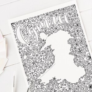 May include: A black and white printable coloring page featuring the word "Gemini" surrounded by a pattern of hearts, flowers, fish, and sailboats.