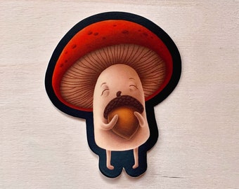 Può includere: Un fungo di cartone animato con un cappello rosso e un gambo marrone tiene una ghianda nelle sue mani. Il fungo ha un'espressione felice sul suo viso.