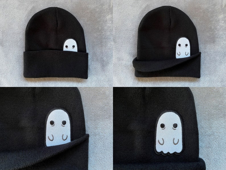 Pu&ograve; includere: Berretto nero con un fantasma bianco ricamato sul lato. Il fantasma spunta da sotto il bordo piegato del berretto.