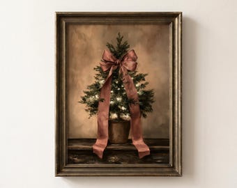May include: A framed wall art print depicting a small potted evergreen tree adorned with glowing white string lights and a large, draped dusty rose ribbon. The tree sits on a dark wooden surface against a muted, warm-toned, textured background.