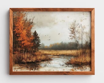 May include: A framed landscape painting depicting an autumn scene with orange and brown trees, a calm body of water, and tall grasses. The sky is overcast with a few birds in flight. The artwork is enclosed in a simple, medium-toned wooden frame.