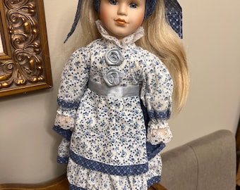 Vintage Porcelain Doll in White Blue Floral Dress, Smiling